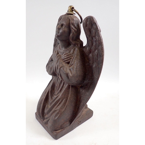 1109 - A cast iron kneeling angel with ring fitting to top, 22cm