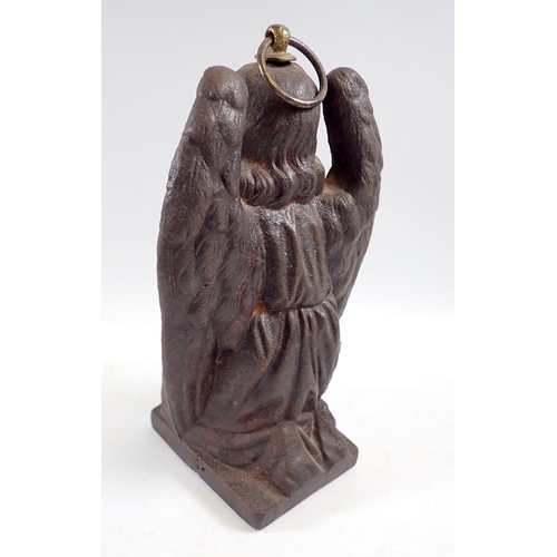 1109 - A cast iron kneeling angel with ring fitting to top, 22cm