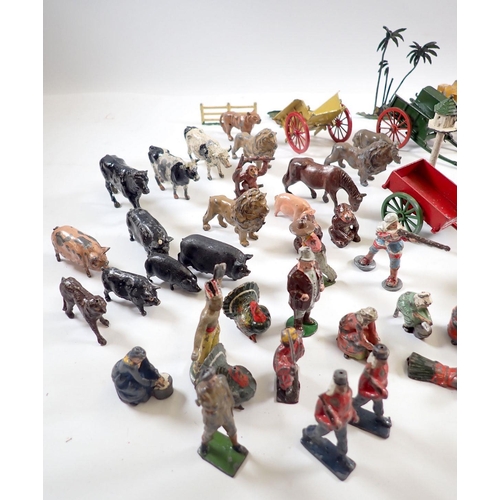 1117 - A group of Britains and various metal painted figures, farm trailers, animals etc.