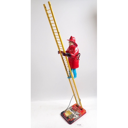 1125 - A Mar Toys metal climbing fireman on ladder, clockwork toy, 58cm tall