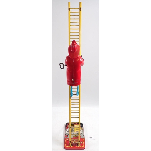 1125 - A Mar Toys metal climbing fireman on ladder, clockwork toy, 58cm tall