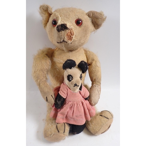 1133 - An Edwardian gold mohair teddy bear, straw filled with glass eyes and stitched nose, 32cm plus a Pan... 