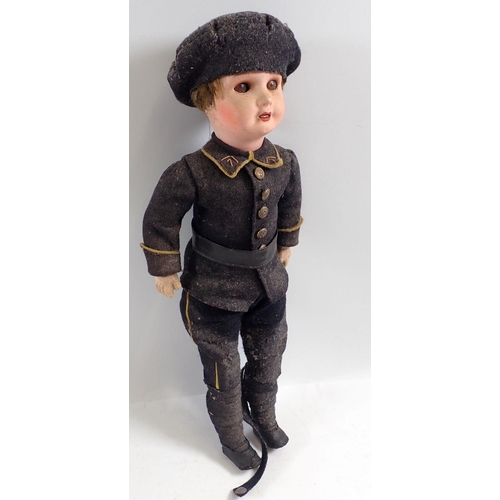 1136 - A WWI SBFJ bisque headed soldier doll in military dress, 39cm tall