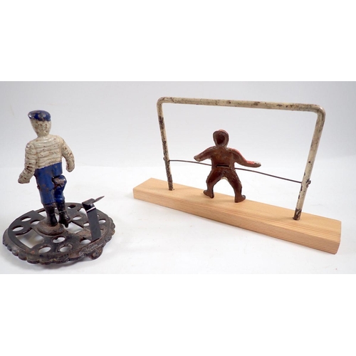 1144 - A Victorian miniature cast iron toy footballer figure with moving leg, 10.5cm tall plus goal keeper ... 