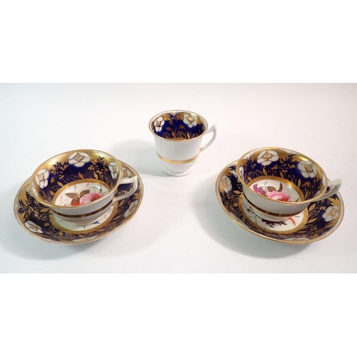 122 - A pair of Victorian cups and saucers painted flowers within deep blue and gilt reserves and a coffee... 