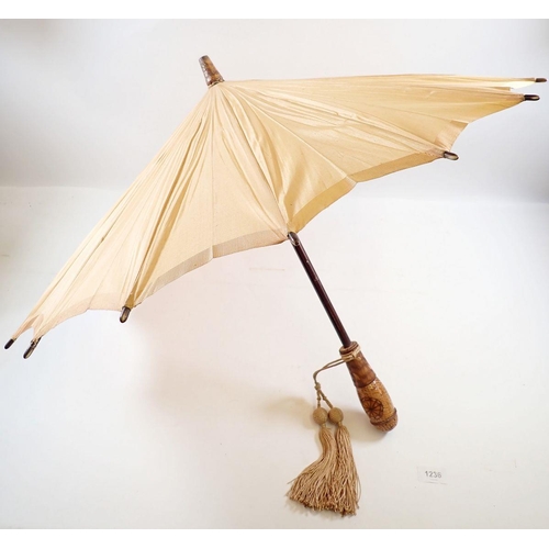 1236 - A Japanese peach silk parasol with carved wooden handle and terminal, 58cm long