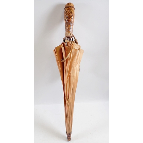 1236 - A Japanese peach silk parasol with carved wooden handle and terminal, 58cm long