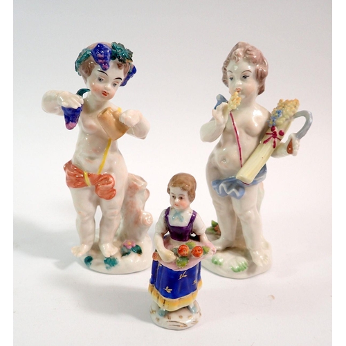 124 - A pair of Capodimonte putti with grapes and corn with Naples mark, 12cm and another figure of an ora... 