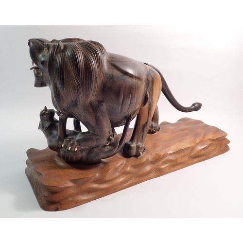 1245 - An oriental rosewood carved lion attacking a tiger, 46cm long