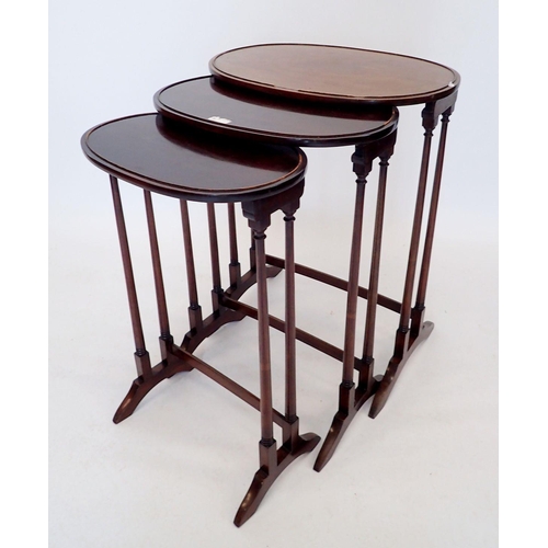 1259 - An oval mahogany set of three occasional tables on slender supports