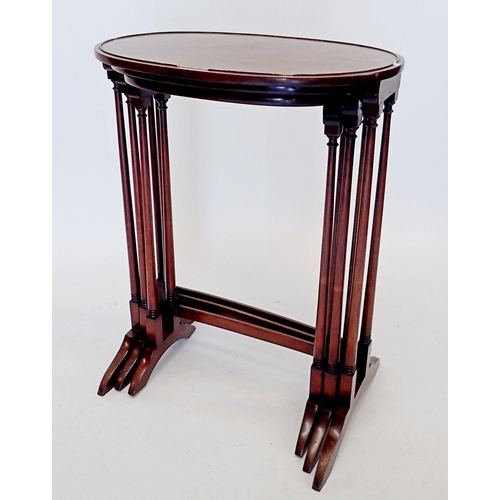 1259 - An oval mahogany set of three occasional tables on slender supports