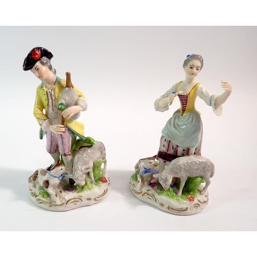 126 - A pair of Volkstedt figures of man and lady with bagpipes, dog and sheep, 16cm