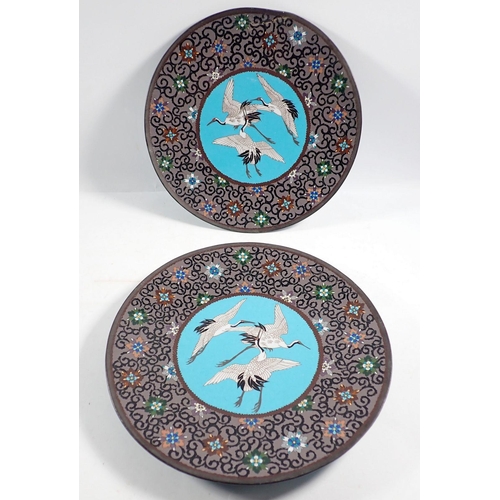 1260 - A pair of Japanese Meiji period cloisonne plates decorated storks, 30cm diameter