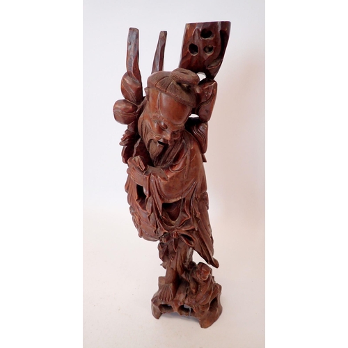 1270 - A large Chinese carved hardwood figure of an Immortal with staff and basket, 72cm tall