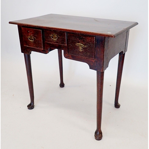 1276 - A George III oak lowboy with three drawers all raised on cylindrical supports and pad feet, 75 x 46 ... 