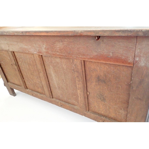 1280 - A large 17th oak coffer with carved triple panelled front and foliage carved sides, 157cm wide