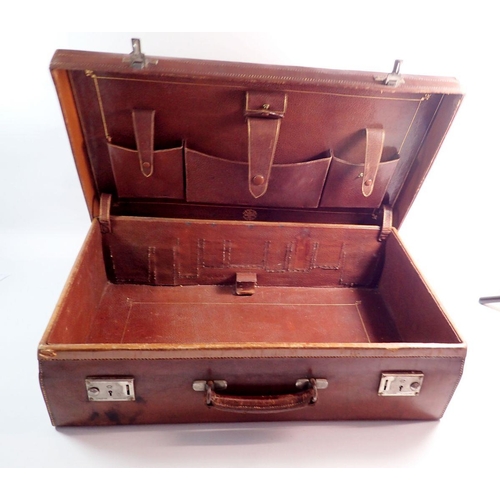 1287 - An antique leather suitcase by Finnigans of London, 61cm wide