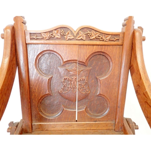 1293 - An oak Glastonbury chair of pegged construction with carved coronet to back