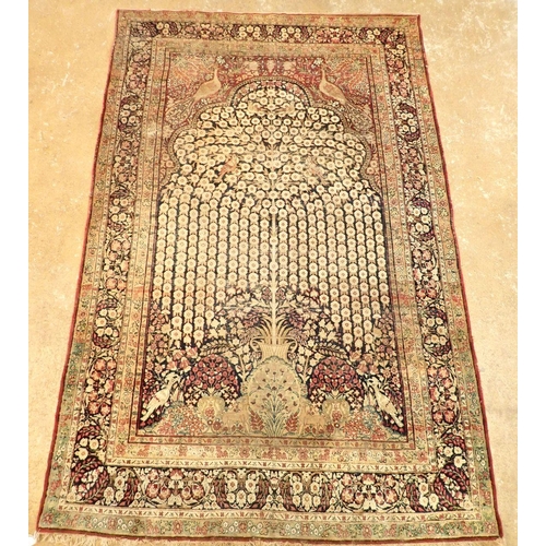 1305 - An antique Persian rug with tree of life on a blue ground with birds and peacocks within floral bord... 