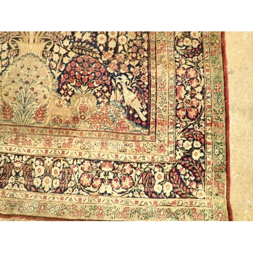 1305 - An antique Persian rug with tree of life on a blue ground with birds and peacocks within floral bord... 