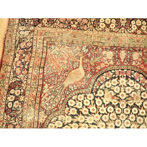 1305 - An antique Persian rug with tree of life on a blue ground with birds and peacocks within floral bord... 