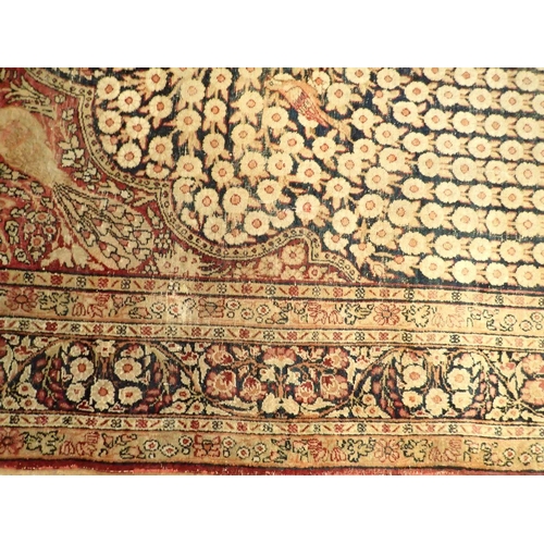 1305 - An antique Persian rug with tree of life on a blue ground with birds and peacocks within floral bord... 