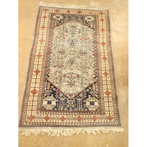 1307 - A Turkoman style rug with stylised floral motifs on a blue grey ground 188 x 123cm