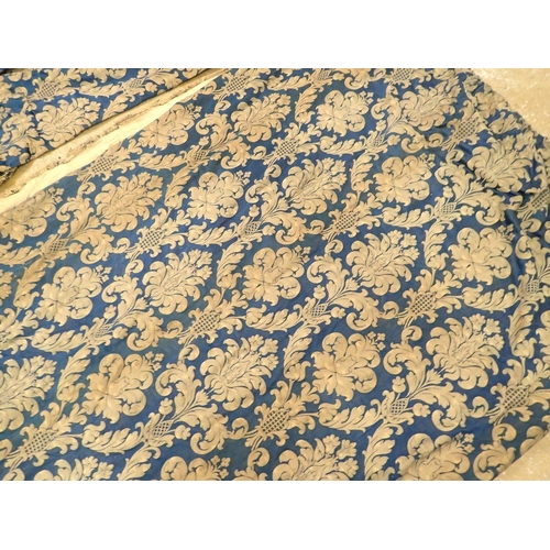 1317 - A pair of vintage blue and gilt foliate curtains with velvet banding, 216cm wide x 267cm drop