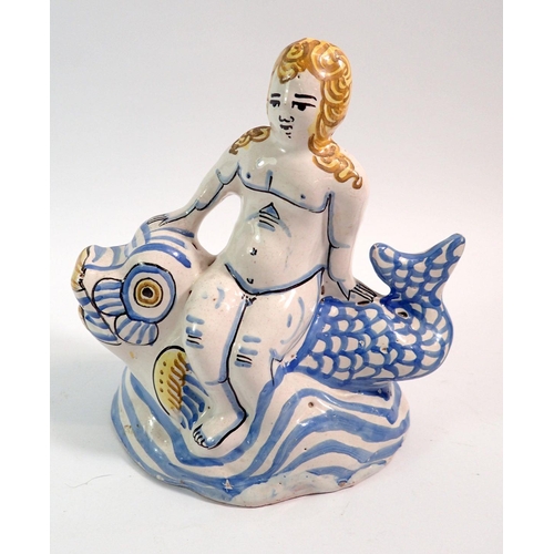 133 - An 18th century Delft figure of a woman seated on a fish, 18.5cm tall, with authentication certifica... 