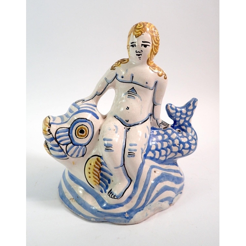 133 - An 18th century Delft figure of a woman seated on a fish, 18.5cm tall, with authentication certifica... 