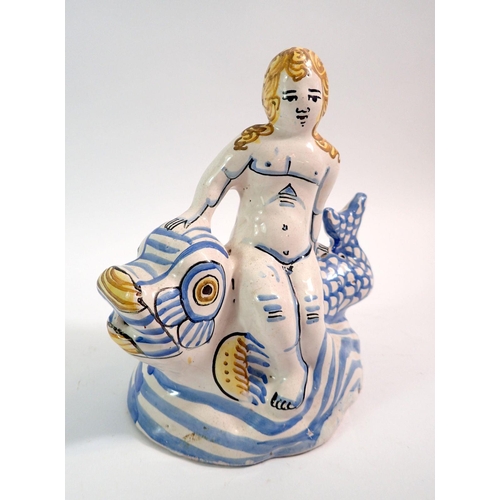 133 - An 18th century Delft figure of a woman seated on a fish, 18.5cm tall, with authentication certifica... 