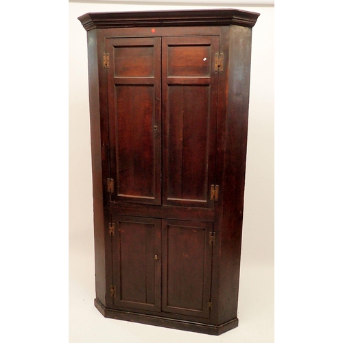 1345 - A Georgian oak corner cupboard with two pairs of panelled doors, 196cm tall x 105cm wide