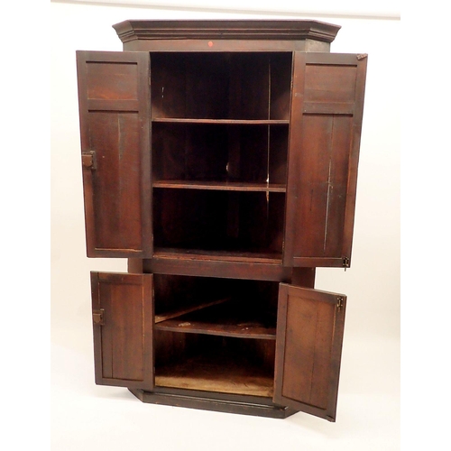 1345 - A Georgian oak corner cupboard with two pairs of panelled doors, 196cm tall x 105cm wide