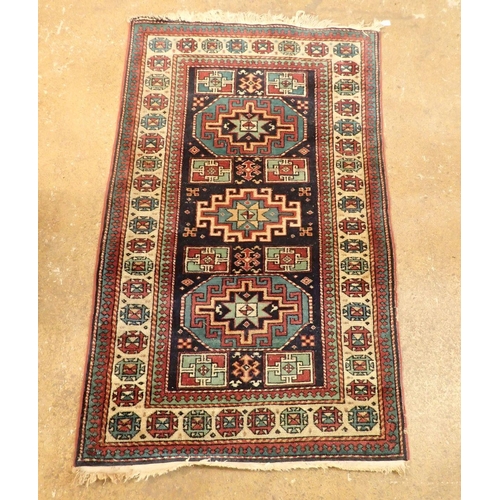 1347 - A Turkoman rug with three geometric medallions on a blue ground 161 x 98cm