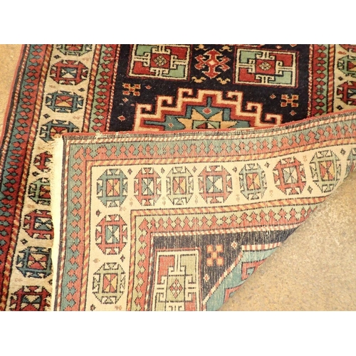 1347 - A Turkoman rug with three geometric medallions on a blue ground 161 x 98cm