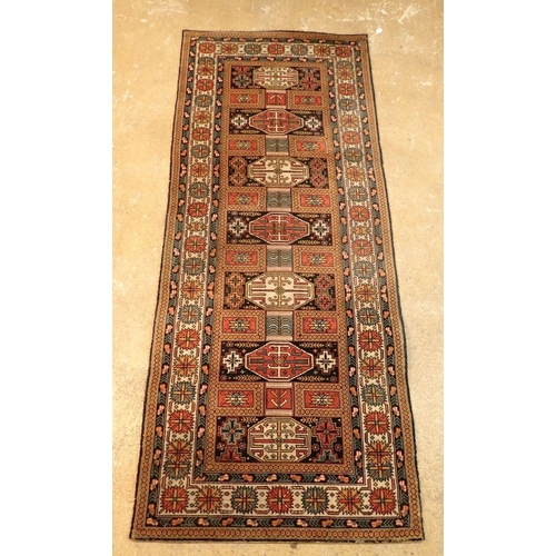 1348 - A machine made Turkoman style rug with geometric motifs 230 x 93cm