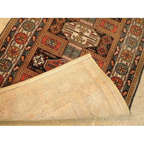 1348 - A machine made Turkoman style rug with geometric motifs 230 x 93cm