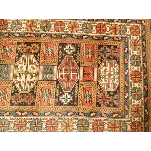 1348 - A machine made Turkoman style rug with geometric motifs 230 x 93cm