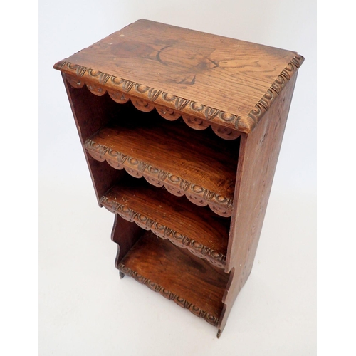 1349 - An oak three-tier narrow bookcase with rustic carved decoration, width 46cm