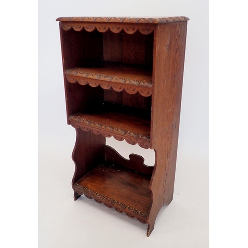 1349 - An oak three-tier narrow bookcase with rustic carved decoration, width 46cm