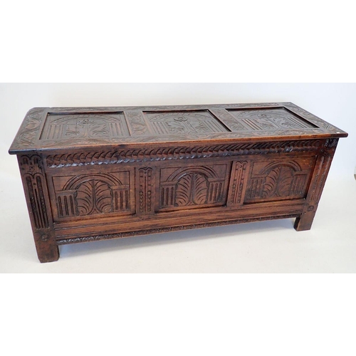 1372 - An early 18th century oak coffer with triple panel arch carved front, 152cm wide