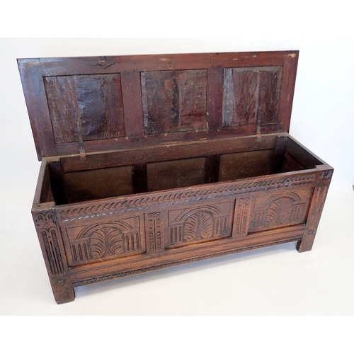 1372 - An early 18th century oak coffer with triple panel arch carved front, 152cm wide