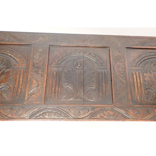 1372 - An early 18th century oak coffer with triple panel arch carved front, 152cm wide