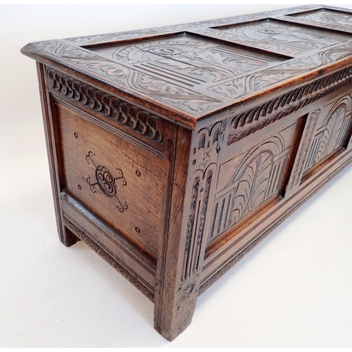 1372 - An early 18th century oak coffer with triple panel arch carved front, 152cm wide