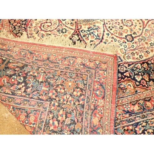 1373 - A large Persian carpet with medallion and scrolling floral design within multiple borders 440 x 311c... 