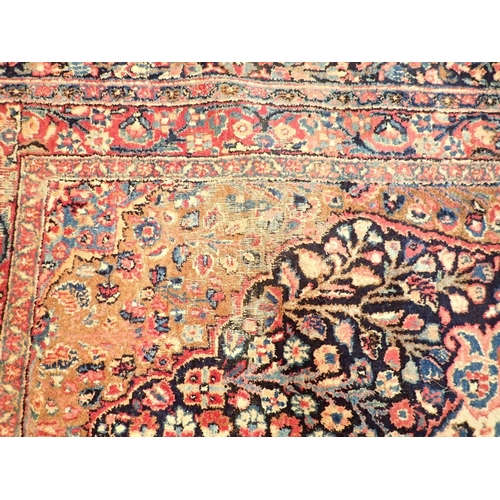 1373 - A large Persian carpet with medallion and scrolling floral design within multiple borders 440 x 311c... 