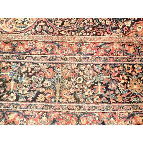 1373 - A large Persian carpet with medallion and scrolling floral design within multiple borders 440 x 311c... 