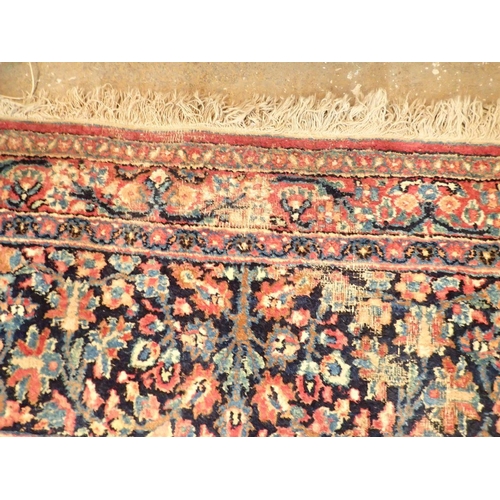 1373 - A large Persian carpet with medallion and scrolling floral design within multiple borders 440 x 311c... 