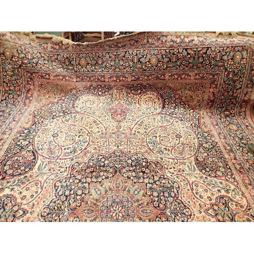 1373 - A large Persian carpet with medallion and scrolling floral design within multiple borders 440 x 311c... 