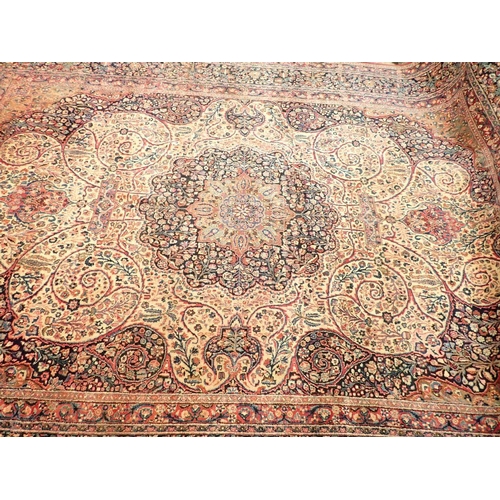 1373 - A large Persian carpet with medallion and scrolling floral design within multiple borders 440 x 311c... 